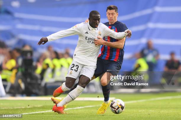 Ferland Mendy of Real Madrid is challenged by Robert Lewandowski of FC Barcelona during the LaLiga Santander match between Real Madrid CF and FC...