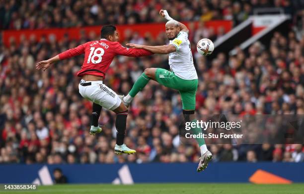 Newcastle United player Joelinton is challenged by by Manchester United Casemiro during the Premier League match between Manchester United and...