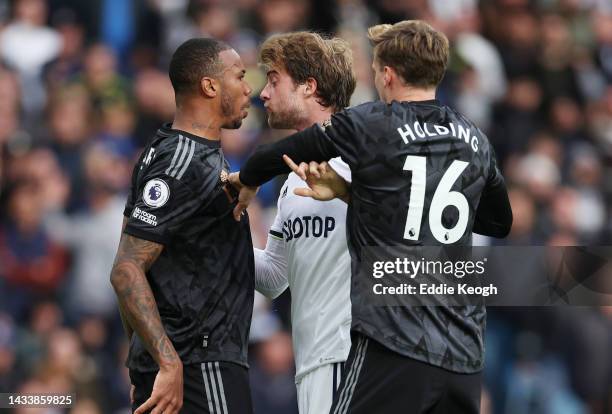 Gabriel Magalhaes and Rob Holding of Arsenal clash with Patrick Bamford of Leeds United during the Premier League match between Leeds United and...