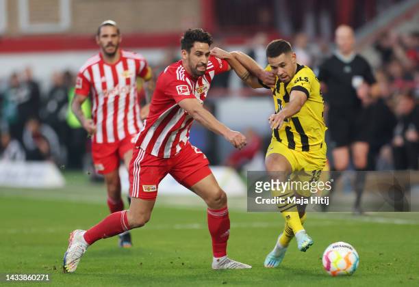 Rani Khedira of 1.FC Union Berlin battles for possession with Raphael Guerreiro of Borussia Dortmund during the Bundesliga match between 1. FC Union...