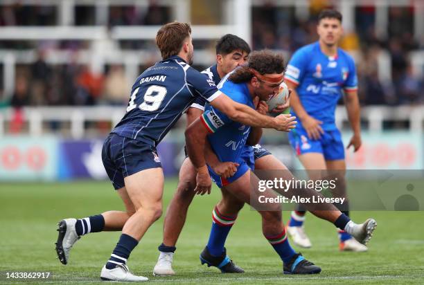 Brenden Santi of Italy is tackled by Calum Gahan and James Bell of Scotland during Rugby League World Cup 2021 Pool B match between Scotland and...