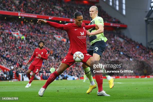 Virgil van Dijk of Liverpool holds off Erling Haaland of Manchester City during the Premier League match between Liverpool FC and Manchester City at...