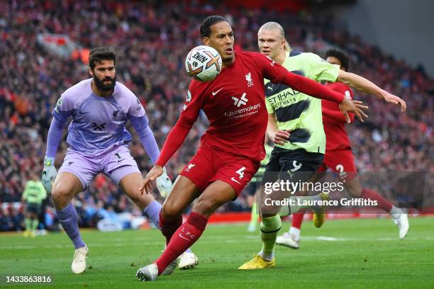 Virgil van Dijk of Liverpool holds off Erling Haaland of Manchester City during the Premier League match between Liverpool FC and Manchester City at...