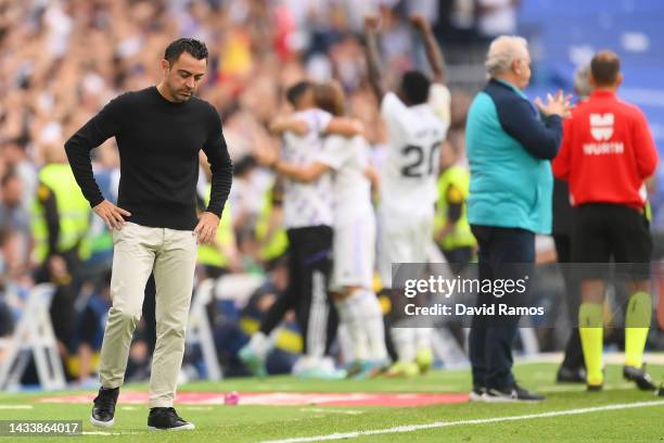 Xavi, Head Coach of FC Barcelona reacts after Rodrygo of Real Madrid scored their sides third goal during the LaLiga Santander match between Real...