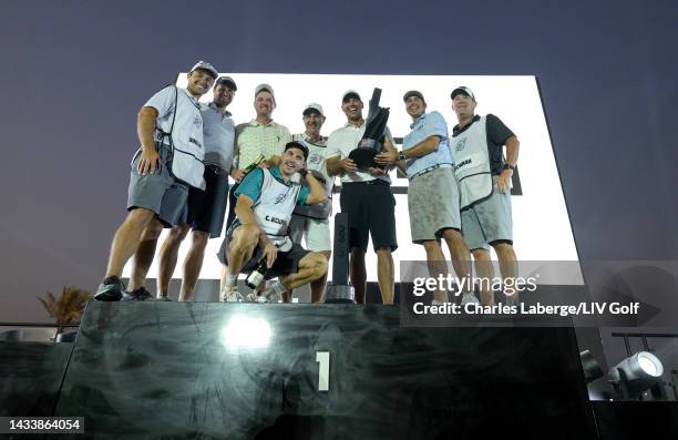 Peter Uihlein, Jason Kokrak, Team Captain Brooks Koepka, Chase Koepka of Smash GC and caddies celebrate with the trophy on the podium after winning...