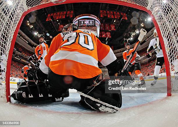 Andreas Lilja, Ilya Bryzgalov and Eric Wellwood of the Philadelphia Flyers defend their crease against the Pittsburgh Penguins in Game Six of the...