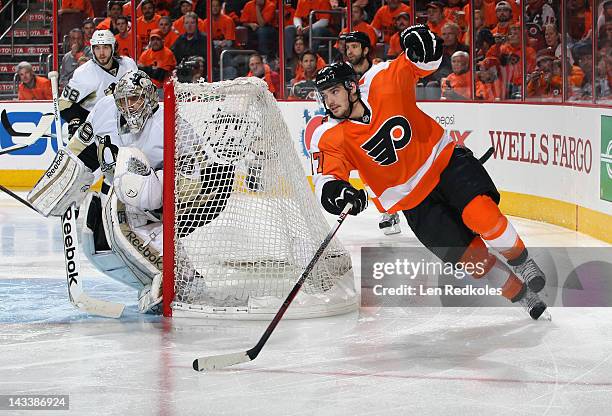 Eric Wellwood of the Philadelphia Flyers skates around the net against Marc-Andre Fleury and Kris Letang of the Pittsburgh Penguins in Game Six of...