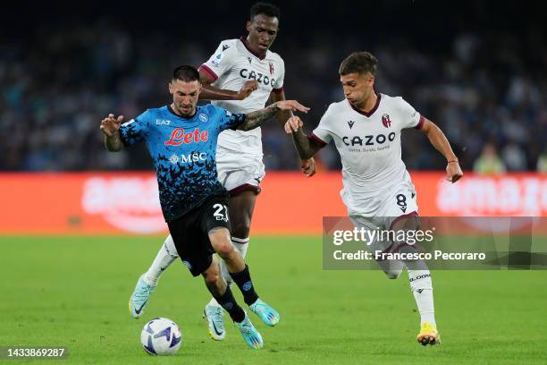 Matteo Politano of SSC Napoli battles for possession with Jhon Lucumi and Nicolas Dominguez of Bologna FC during the Serie A match between SSC Napoli...