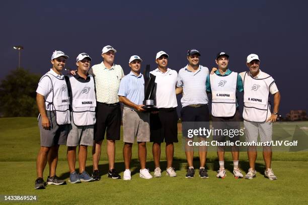 Jason Kokrak, Chase Koepka, Team Captain Brooks Koepka and Peter Uihlein of Smash GC celebrate their team win with the trophy and their caddies...