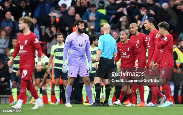 Alisson Becker and Thiago Alcantara of Liverpool remonstrate with referee Anthony Taylor during the Premier League match between Liverpool FC and...