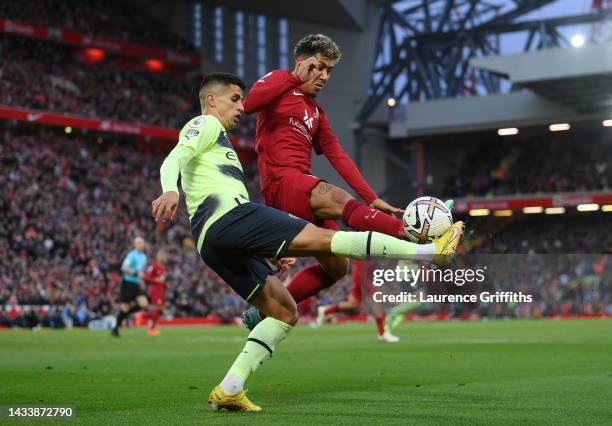 Joao Cancelo of Manchester City and Roberto Firmino of Liverpool battle for possession during the Premier League match between Liverpool FC and...