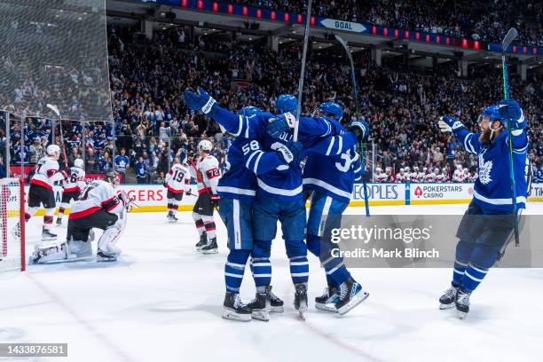 Justin Holl of the Toronto Maple Leafs celebrates his goal against the Ottawa Senators with teammates Michael Bunting, Auston Matthews and Jake...