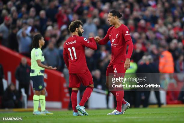 Mohamed Salah of Liverpool celebrates with teammate Virgil van Dijk after scoring their side's first goal during the Premier League match between...