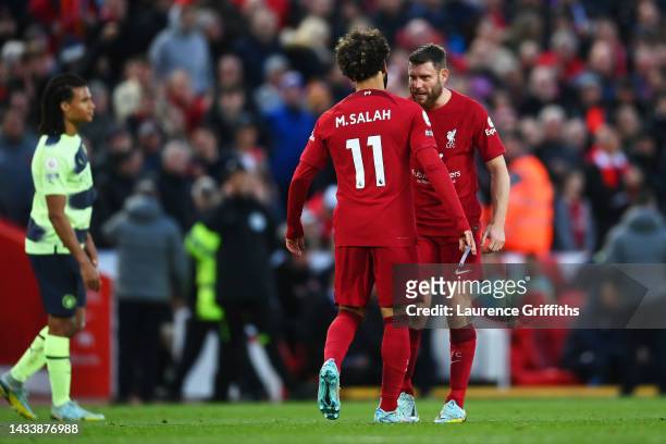 Mohamed Salah of Liverpool celebrates with teammate James Milner after scoring their side's first goal during the Premier League match between...