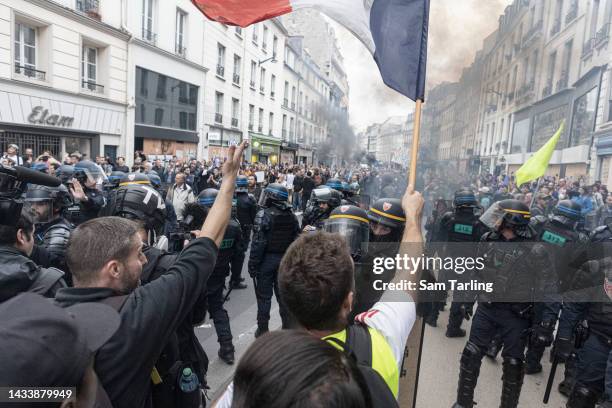 Police and protesters clash at a demonstration against the rising cost of living and climate inaction on October 16, 2022 in Paris, France. Some...