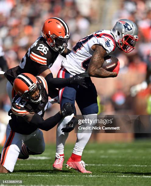 John Johnson III of the Cleveland Browns and Greedy Williams of the Cleveland Browns tackle Kendrick Bourne of the New England Patriots during the...