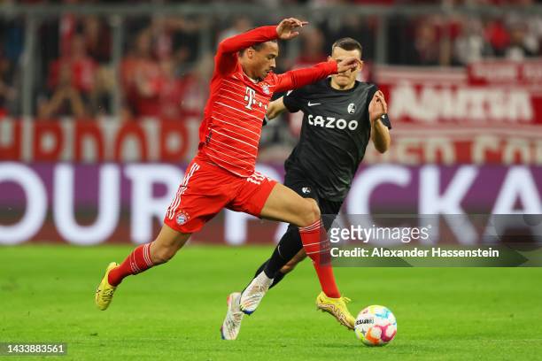 Leroy Sane of Bayern Munich is challenged by Maximilian Eggestein of SC Freiburg during the Bundesliga match between FC Bayern München and Sport-Club...