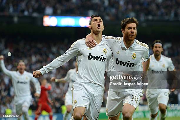 Cristiano Ronaldo of Real Madrid celebrates scoring from the penalty spot with Xabi Alonso of Real Madrid during the UEFA Champions League Semi Final...