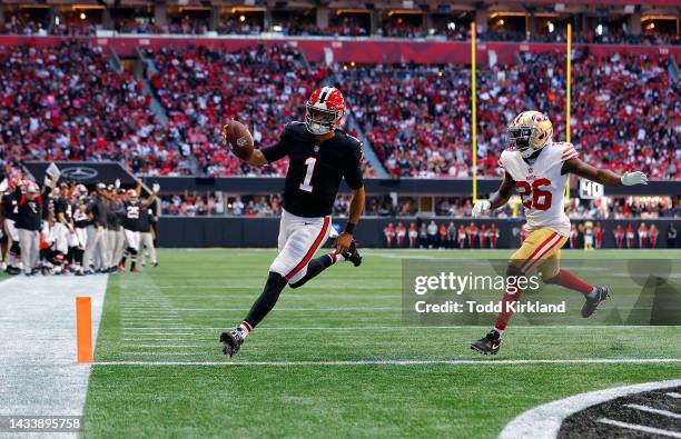 Marcus Mariota of the Atlanta Falcons runs past Samuel Womack III of the San Francisco 49ers while scoring a touchdown during the second quarter at...