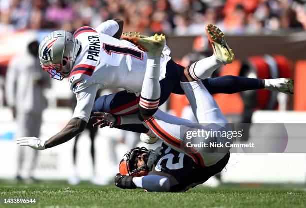 DeVante Parker of the New England Patriots is tackled by Martin Emerson Jr. #23 of the Cleveland Browns during the first quarterat FirstEnergy...