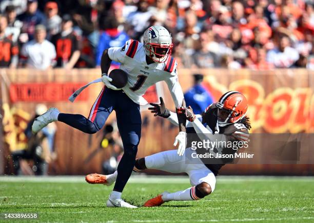 DeVante Parker of the New England Patriots is tackled by Martin Emerson Jr. #23 of the Cleveland Browns during the first quarterat FirstEnergy...