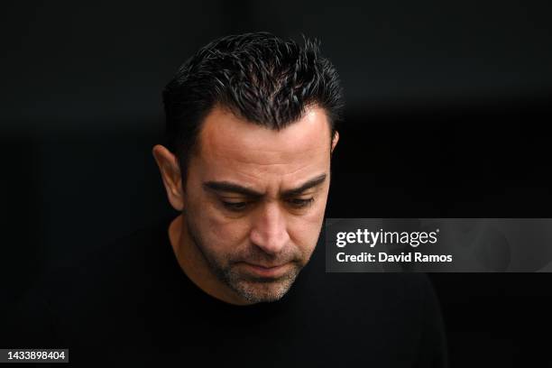 Head coach Xavi Hernandez of FC Barcelona looks down prior to the LaLiga Santander match between Real Madrid CF and FC Barcelona at Estadio Santiago...