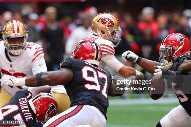 Jimmy Garoppolo of the San Francisco 49ers fumbles the ball while being hit by Grady Jarrett of the Atlanta Falcons during the second quarter at...
