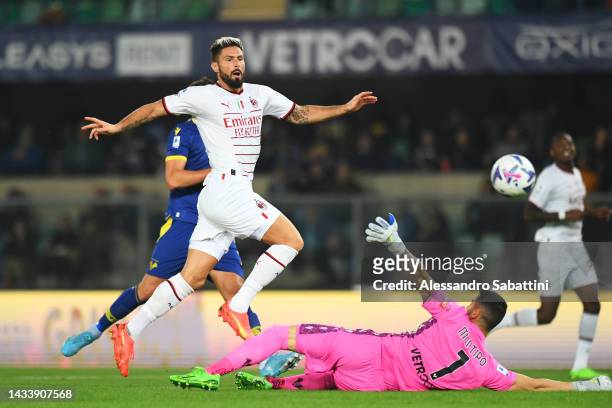 Olivier Giroud of AC Milan shoots and misses as Lorenzo Montipo of Hellas Verona attempts to save during the Serie A match between Hellas Verona and...