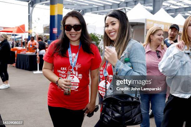 Volunteers participate at the Food Network New York City Wine & Food Festival presented by Capital One - Grand Tasting featuring Culinary...