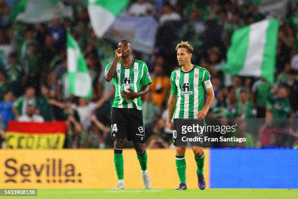 William Carvalho of Real Betis celebrates with teammate Sergio Canales after scoring their team's first goal during the LaLiga Santander match...