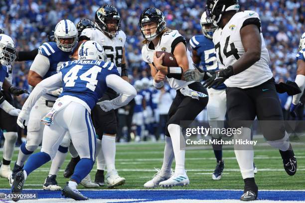 Trevor Lawrence of the Jacksonville Jaguars scores a touchdown against the Indianapolis Colts during the third quarter at Lucas Oil Stadium on...