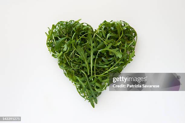 heart-shaped formed by fresh arugula - arugula stock pictures, royalty-free photos & images