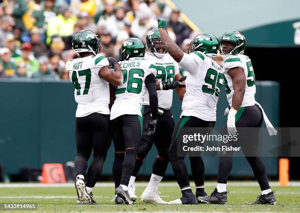 New York Jets defensive players celebrate in the fourth quarter of game against the Green Bay Packers at Lambeau Field on October 16, 2022 in Green...