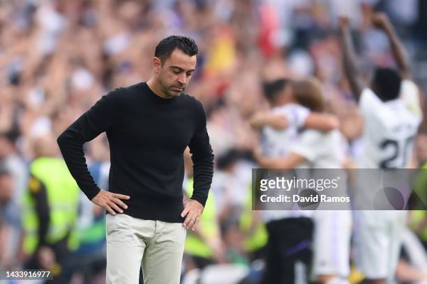 Head coach Xavi Hernandez of FC Barcelona looks on dejected during the LaLiga Santander match between Real Madrid CF and FC Barcelona at Estadio...