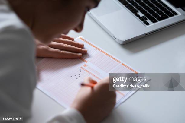 hand fill in exam carbon paper computer sheet and pencil - multiple choice stock pictures, royalty-free photos & images