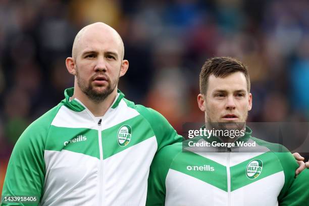 George King and Luke Keary of Ireland sing their national anthem prior to the Rugby League World Cup 2021 Pool C match between Jamaica and Ireland at...