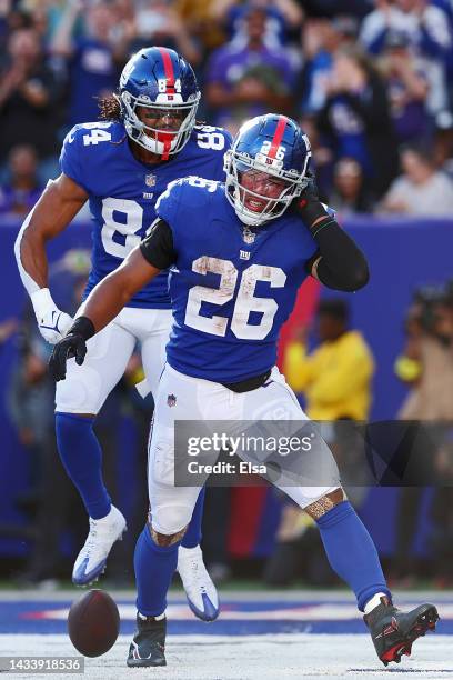 Saquon Barkley of the New York Giants celebrates with Marcus Johnson after scoring a touchdown during the fourth quarter against the Baltimore Ravens...