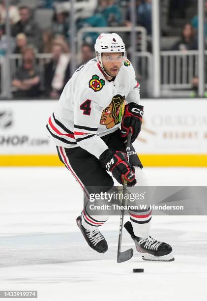 Seth Jones of the Chicago Blackhawks skates up ice with control of the puck against the San Jose Sharks in the first period of an NHL Hockey game at...