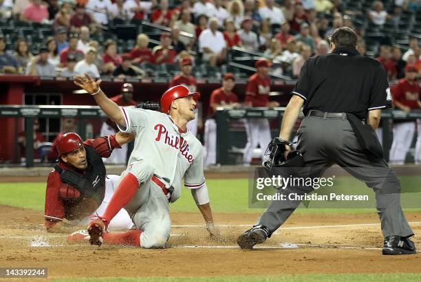 Hunter Pence of the Philadelphia Phillies is tagged out at home plate by catcher Henry Blanco of the Arizona Diamondbacks during the first inning of...