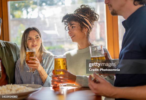 friends having fun in a bar - lager stock pictures, royalty-free photos & images