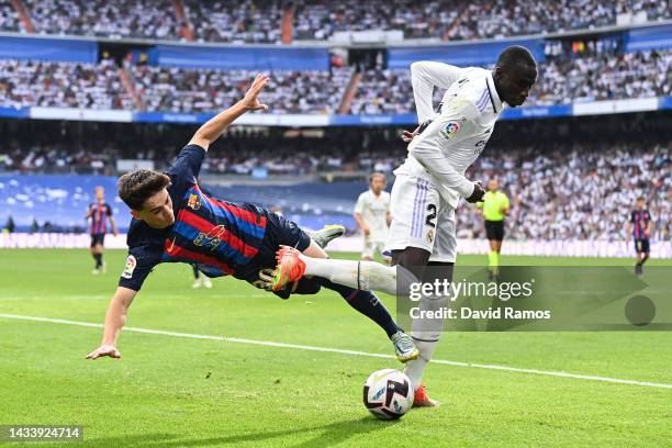 Gavi of FC Barcelona battles for possession with Ferland Mendy of Real Madrid during the LaLiga Santander match between Real Madrid CF and FC...