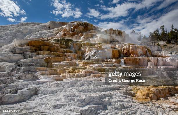 Dramatic mineral terraces are viewed near the Park Headquarters on September 21 in Mammoth Hot Springs, Yellowstone National Park, Wyoming. Sitting...