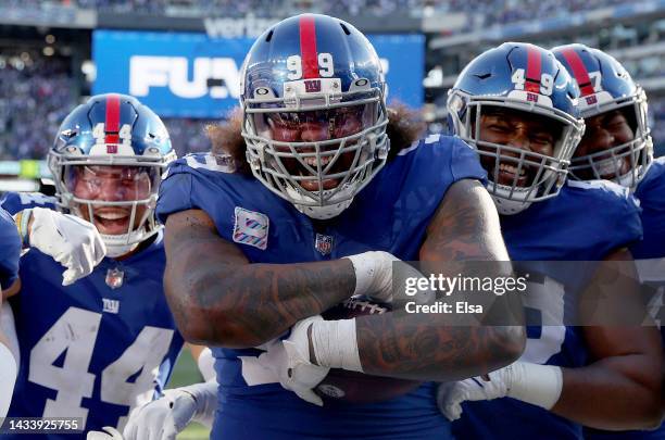 Leonard Williams of the New York Giants celebrates with teammates Tomon Fox and Nick McCloud after he recovered a fumble in the fourth quarter...