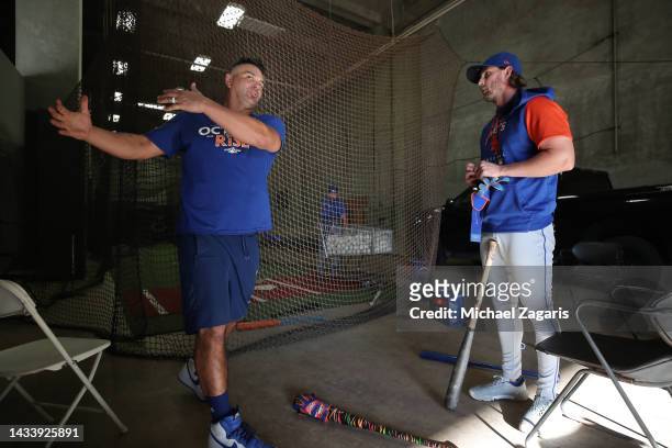 Hitting Coach Eric Chavez and Jeff McNeil of the New York Mets in the batting cage before the game against the Oakland Athletics at RingCentral...