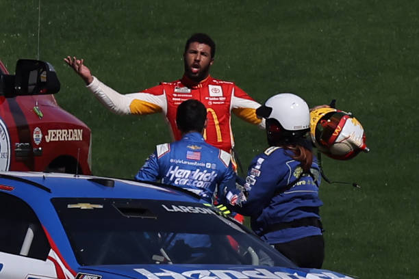 Bubba Wallace, driver of the McDonald's Toyota, confronts Kyle Larson, driver of the HendrickCars.com Chevrolet, after an on-track incident during...