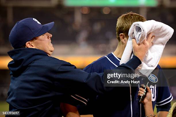 Cory Luebke of the San Diego Padres is hit by a shaving cream pie by teammate Tim Stauffer after the game against the Philadelphia Phillies at Petco...