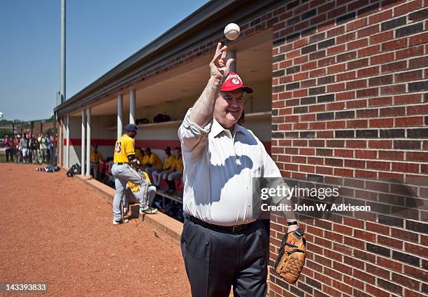 Republican presidential candidate, former Speaker of the House Newt Gingrich warms up his arm prior to throwing out the first pitch at a baseball...