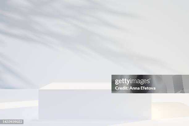 cube shape white podium on white background with many plant shadows. perfect platform for showing your products. three dimensional illustration - stage background stock-fotos und bilder
