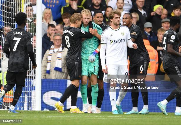 Arsenal captain Martin Odegaard hugs Aaron Ramsdale after the Leeds penalty miss during the Premier League match between Leeds United and Arsenal FC...