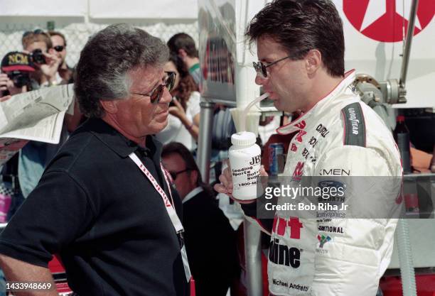 Racer Michael Andretti speaks with his father Mario Andretti prior to the Long Beach Grand Prix Race, April 11, 1997 in Long Beach, California.